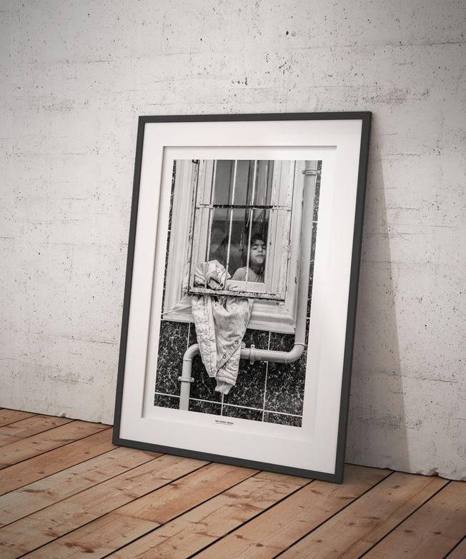 The Turkey Series - A Syrian girl in a window in Al Fatih, Istanbul. Photo by photographer Martin Thaulow. Open Edition (seen in a frame in an environment. The frame is not part of sale). Buy high quality print.