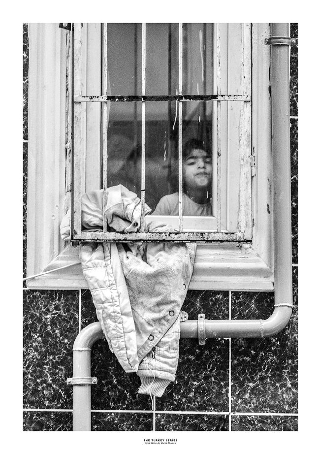 The Turkey Series - A Syrian girl in a window in Al Fatih, Istanbul. Photo by photographer Martin Thaulow. Open Edition (seen with the white frame around the image as it is sold). Buy high quality print.